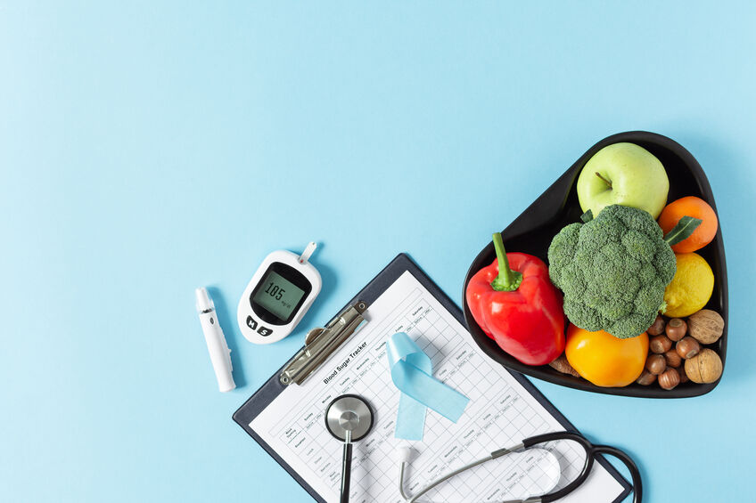 Fresh vegetables and fruit with glucometer top view on blue back